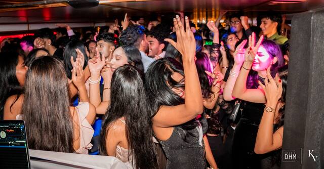 The packed top deck of a MUIC boat party