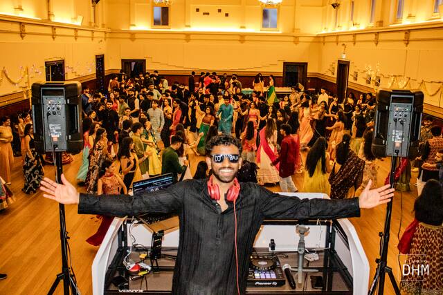 The MC leading the crowd at Garba