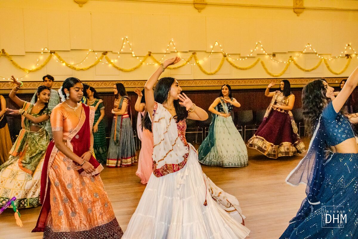 A dancer mid-twirl in a flowing lehenga at Garba
