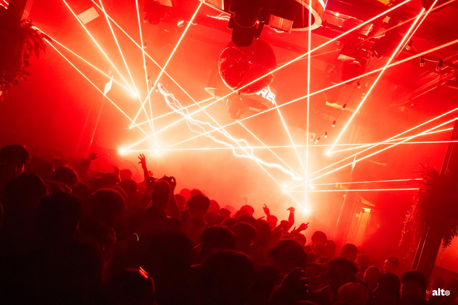 Lasers cutting across a packed dance floor at a MUIC takeover