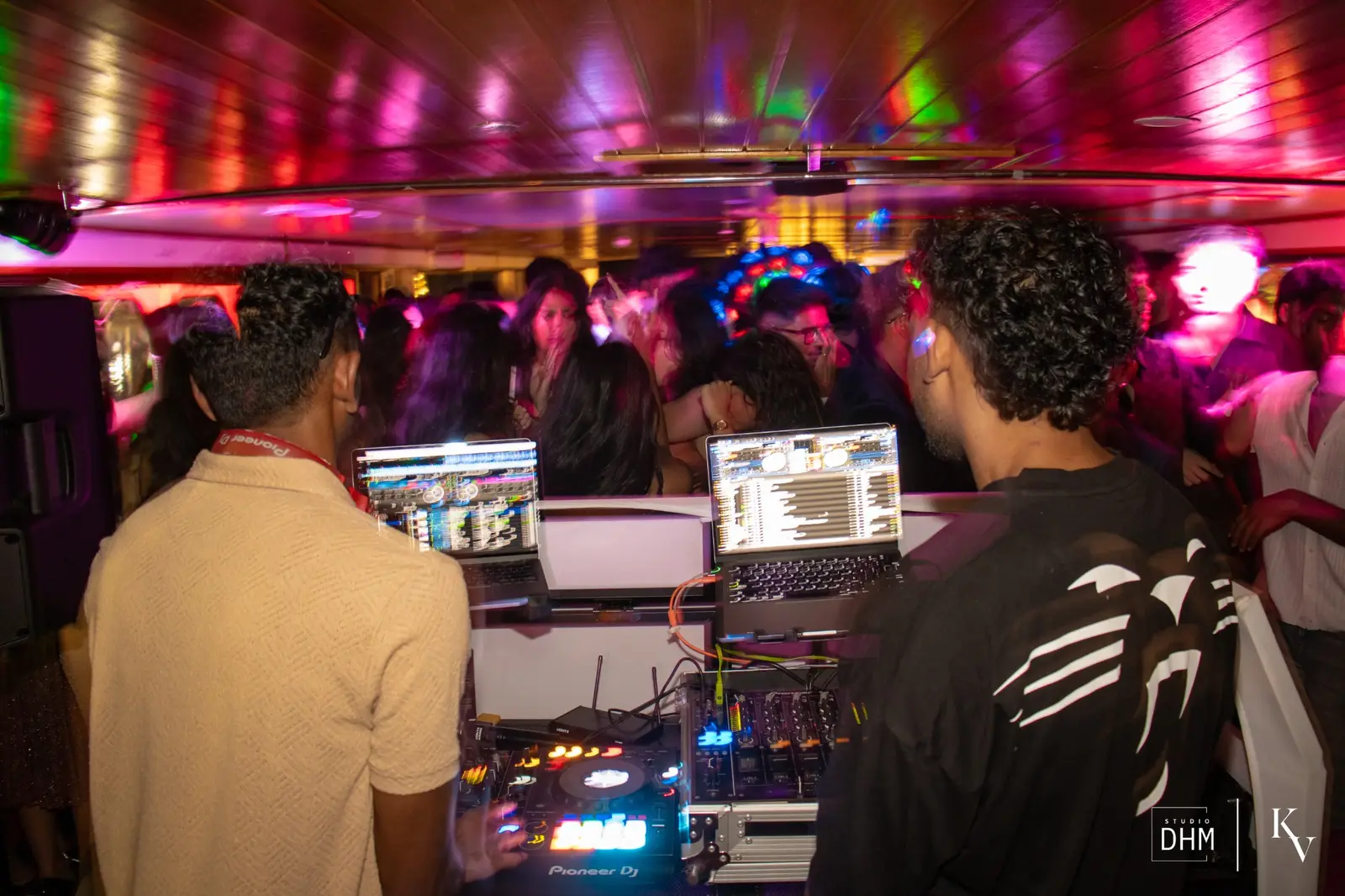 MUIC committee running the decks behind the DJ booth
