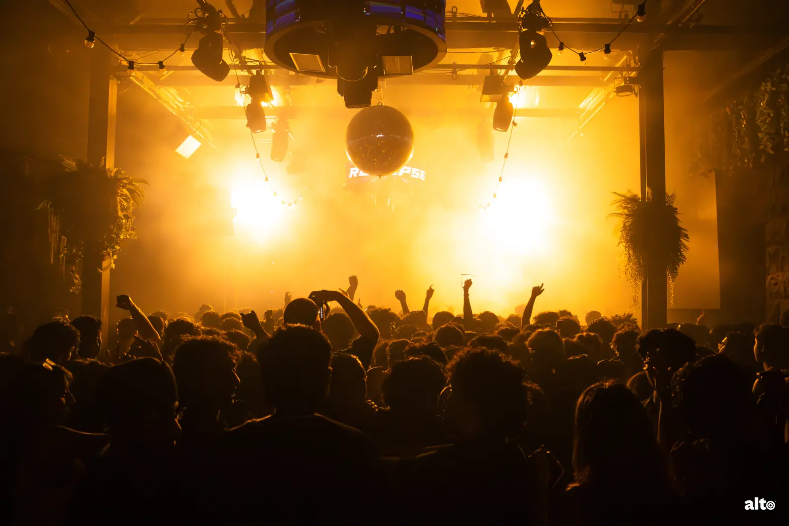 A packed MUIC crowd lit in warm light